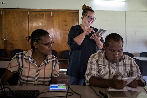 Amber from Oikoi assists a NARI staff member during a CommCare training delivered by AgImpact at the NARI research station in Leh, in Eastern Highlands Province of Papua New Guinea. AgImpact is delivering a Short Research Assignment for ACIAR exploring the uptake of using apps on tablets for agricultural research