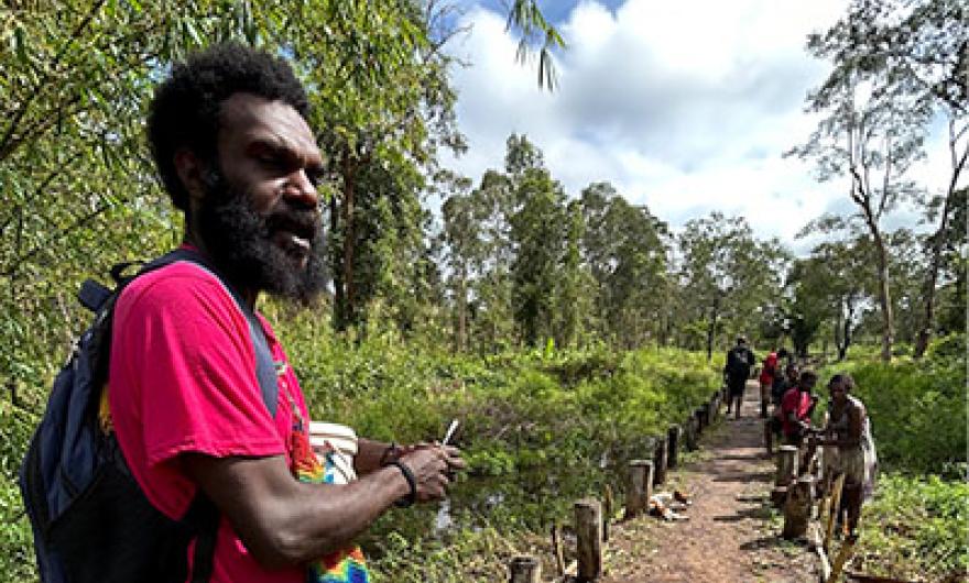 A man standing at the beginning of a road.